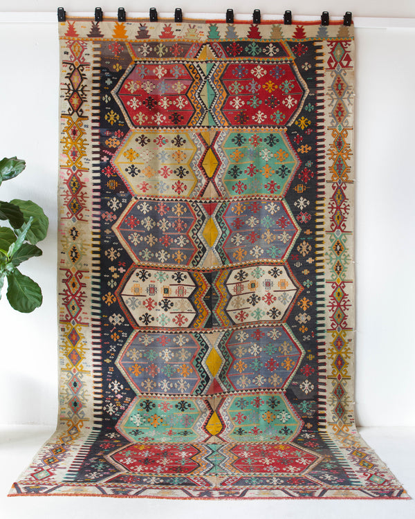 Vintage kilim rug in room decor setting, old rug, antique rug, pastel colors, faded colors, Turkish rug, vintage rug, soft rug, Portland, Oregon, rug store, rug shop, local shop, bold colors, bright colors, faded colors