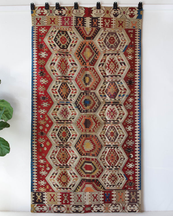 Vintage kilim rug in living room setting, old rug, antique rug, pastel colors, faded colors, Turkish rug, vintage rug, soft rug, Portland, Oregon, rug store, rug shop, local shop, earthy tones, earthy colors, warm colors