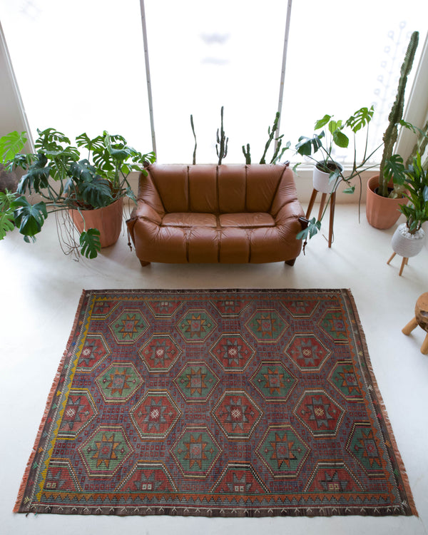 Vintage kilim rug in room decor setting, old rug, antique rug, pastel colors, faded colors, Turkish rug, vintage rug, soft rug, Portland, Oregon, rug store, rug shop, local shop, bold colors, bright colors, faded colors