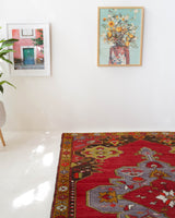 Vintage Turkish rug in a living room setting, pile rug, Turkish rug, vintage rug, portland, rug shop, bright colors, wild shaman, soft rug, bold color, Portland, Oregon, rug store, rug shop, local shop, antique rug