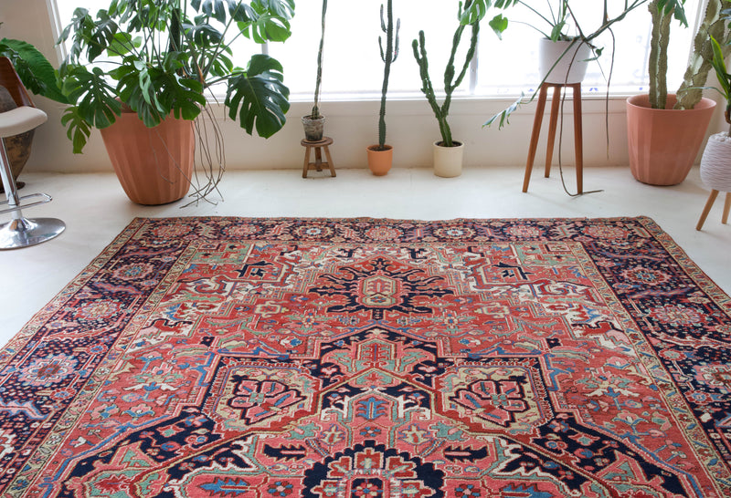 Antique Persian area rug in a living room setting, pile rug, Turkish rug, old rug, antique rug, pastel colors, faded colors, Turkish rug, vintage rug, soft rug, Portland, Oregon, rug store, rug shop, local shop, distressed rug, worn out rug