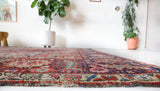 Antique Persian area rug in a living room setting, pile rug, Turkish rug, old rug, antique rug, pastel colors, faded colors, Turkish rug, vintage rug, soft rug, Portland, Oregon, rug store, rug shop, local shop, distressed rug, worn out rug