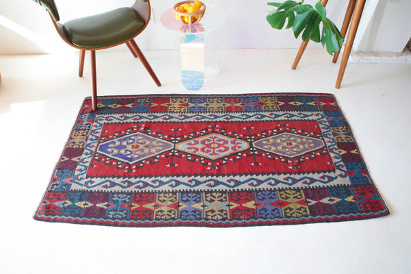 Vintage kilim rug in room decor setting, kilim, Turkish rug, vintage rug, portland, rug shop, bright colors, wild shaman, soft rug, bold color, Portland, Oregon, rug store, rug shop, local shop, antique rug