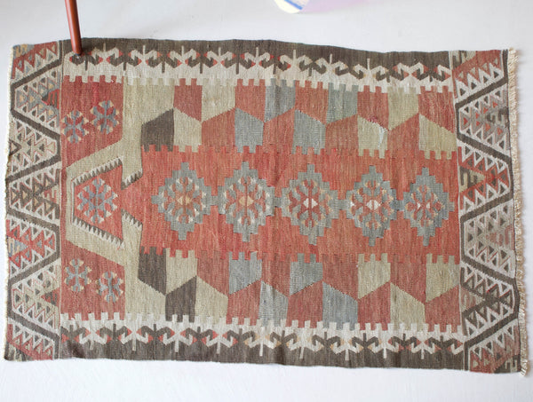  Vintage kilim rug in room decor setting, old rug, antique rug, pastel colors, faded colors, Turkish rug, vintage rug, soft rug, Portland, Oregon, rug store, rug shop, local shop, distressed rug, worn out rug