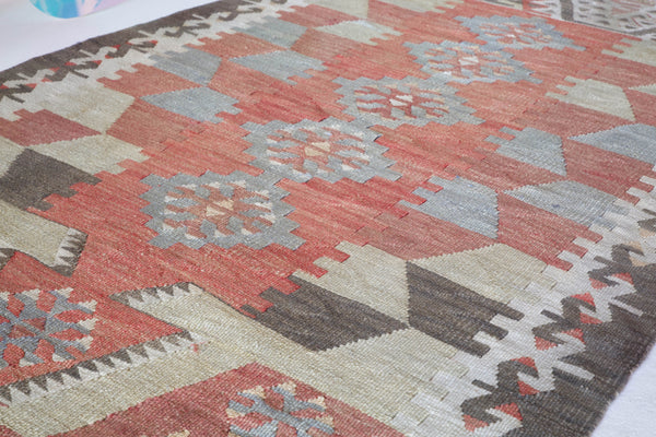  Vintage kilim rug in room decor setting, old rug, antique rug, pastel colors, faded colors, Turkish rug, vintage rug, soft rug, Portland, Oregon, rug store, rug shop, local shop, distressed rug, worn out rug