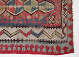 Vintage kilim rug in room decor setting, old rug, antique rug, pastel colors, faded colors, Turkish rug, vintage rug, soft rug, Portland, Oregon, rug store, rug shop, local shop, distressed rug, worn out rug