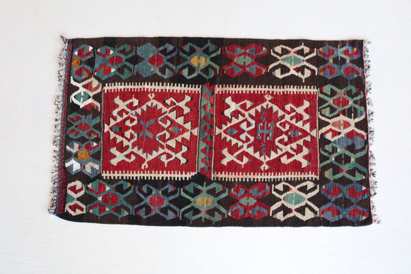 Vintage mini kilim rug in room decor setting, kilim, Turkish rug, vintage rug, portland, rug shop, bright colors, wild shaman, soft rug, bold color, Portland, Oregon, rug store, rug shop, local shop