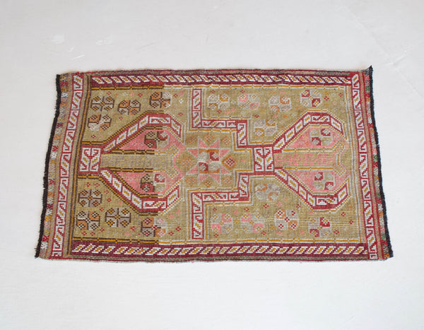 Vintage Turkish mini rug in room decor setting, old rug, antique rug, pastel colors, faded colors, Turkish rug, vintage rug, soft rug, Portland, Oregon, rug store, rug shop, local shop