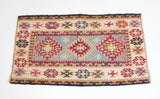 Vintage Turkish mini rug in room decor setting, old rug, antique rug, pastel colors, faded colors, Turkish rug, vintage rug, soft rug, Portland, Oregon, rug store, rug shop, local shop
