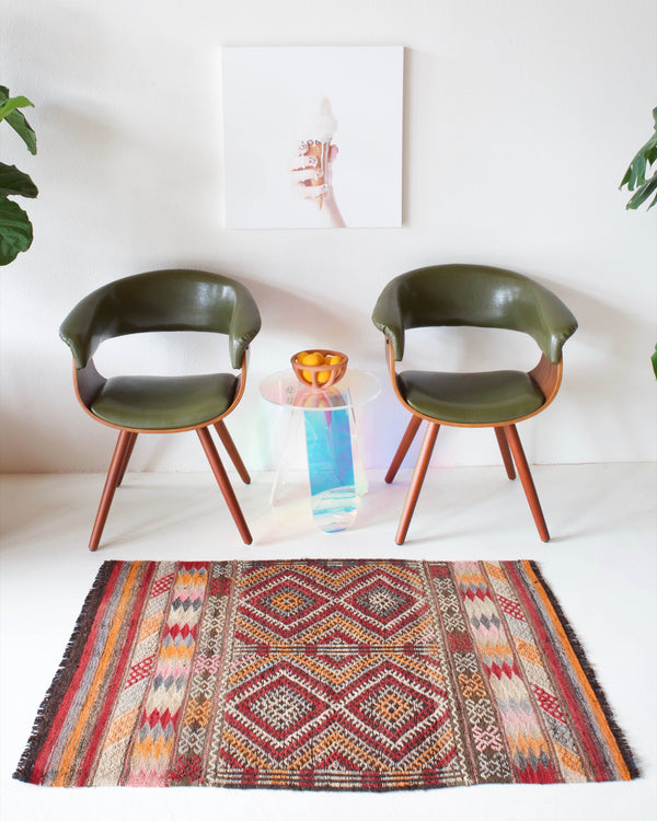 Vintage Turkish mini rug in room decor setting, old rug, antique rug, pastel colors, faded colors, Turkish rug, vintage rug, soft rug, Portland, Oregon, rug store, rug shop, local shop
