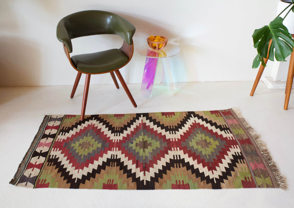 Vintage kilim rug in room decor setting, kilim, Turkish rug, vintage rug, portland, rug shop, bright colors, wild shaman, soft rug, bold color, Portland, Oregon, rug store, rug shop, local shop, antique rug