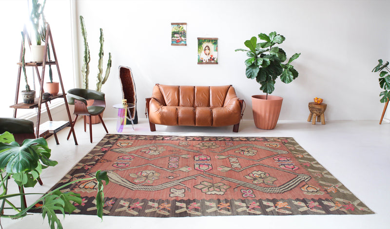 Vintage kilim rug in living room setting, old rug, antique rug, pastel colors, faded colors, Turkish rug, vintage rug, soft rug, Portland, Oregon, rug store, rug shop, local shop