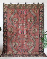 Vintage kilim rug in living room setting, old rug, antique rug, pastel colors, faded colors, Turkish rug, vintage rug, soft rug, Portland, Oregon, rug store, rug shop, local shop