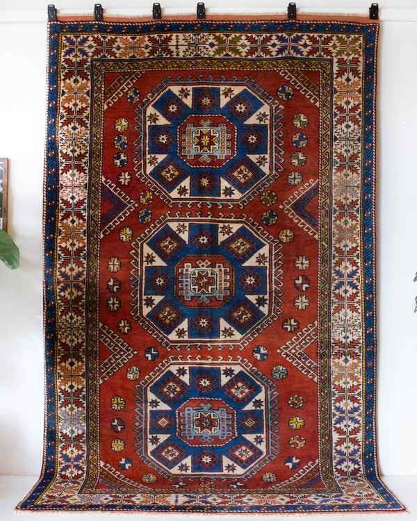 Vintage Turkish rug in a living room setting, pile rug, Turkish rug, vintage rug, portland, rug shop, bright colors, wild shaman, soft rug, bold color, Portland, Oregon, rug store, rug shop, local shop, antique rug