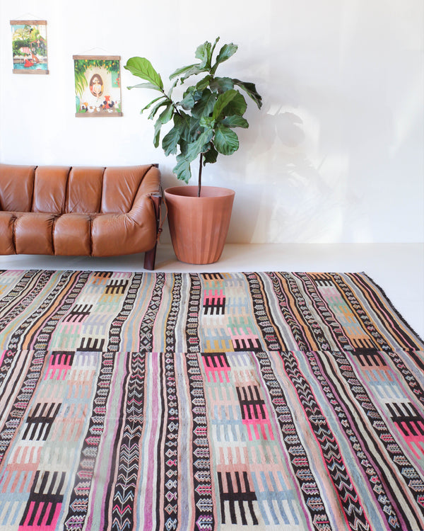 Vintage kilim rug in room decor setting, old rug, antique rug, pastel colors, faded colors, Turkish rug, vintage rug, soft rug, Portland, Oregon, rug store, rug shop, local shop, distressed rug, worn out rug