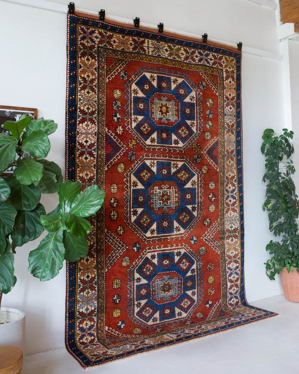 Vintage Turkish rug in a living room setting, pile rug, Turkish rug, vintage rug, portland, rug shop, bright colors, wild shaman, soft rug, bold color, Portland, Oregon, rug store, rug shop, local shop, antique rug