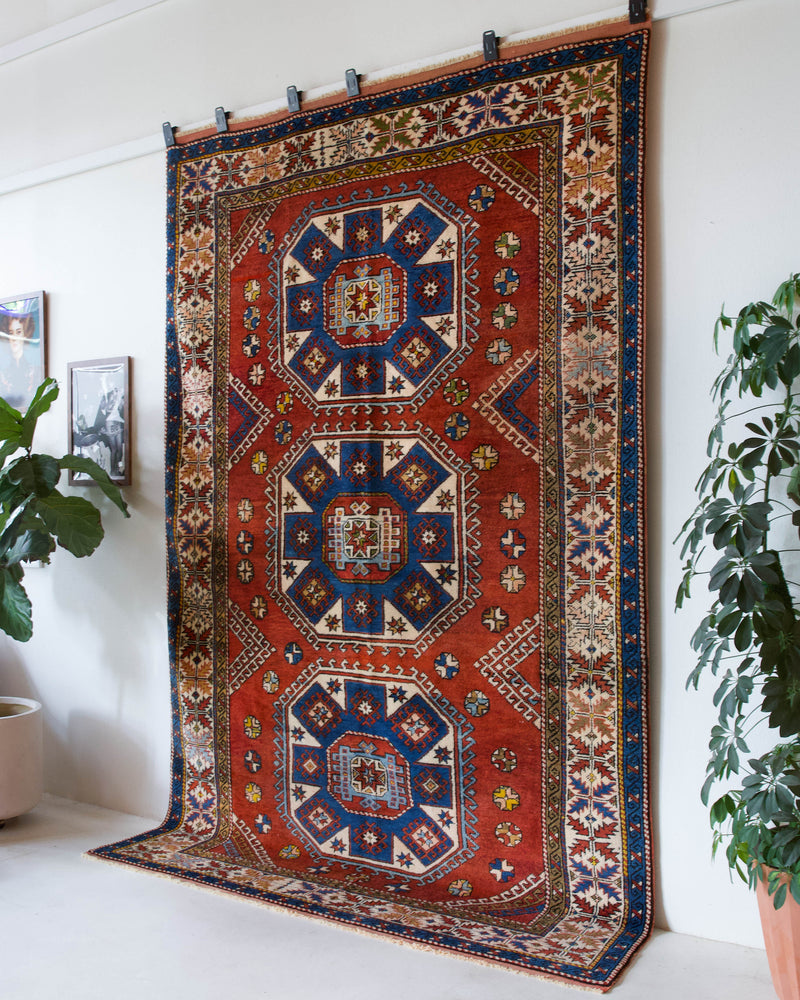 Vintage Turkish rug in a living room setting, pile rug, Turkish rug, vintage rug, portland, rug shop, bright colors, wild shaman, soft rug, bold color, Portland, Oregon, rug store, rug shop, local shop, antique rug