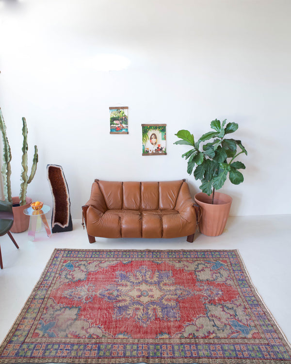 Vintage Turkish  rug in a living room setting, pile rug, Turkish rug, vintage rug, portland, rug shop, bright colors, wild shaman, soft rug, bold color, Portland, Oregon, rug store, rug shop, local shop, antique rug, distressed rug, worn out rug