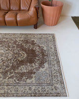 Vintage Turkish rug in living room setting, old rug, antique rug, pastel colors, faded colors, Turkish rug, vintage rug, distressed rug, worn out rug, Portland, Oregon, rug store, rug shop, local shop