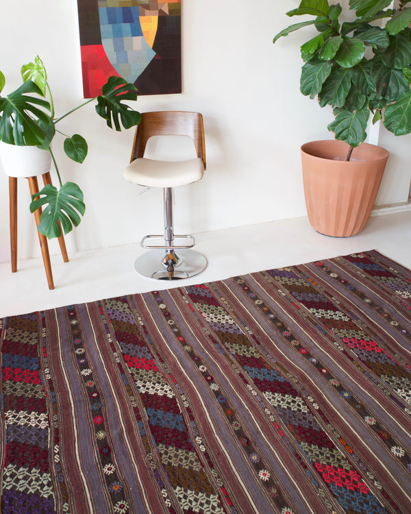 Vintage kilim rug in room decor setting, old rug, antique rug, pastel colors, faded colors, Turkish rug, vintage rug, soft rug, Portland, Oregon, rug store, rug shop, local shop, distressed rug, worn out rug