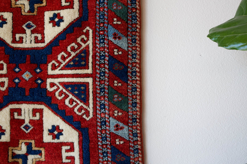 Vintage Turkish runner rug in a living room setting, pile rug, Turkish rug, vintage rug, portland, rug shop, bright colors, wild shaman, soft rug, bold color, Portland, Oregon, rug store, rug shop, local shop, antique rug