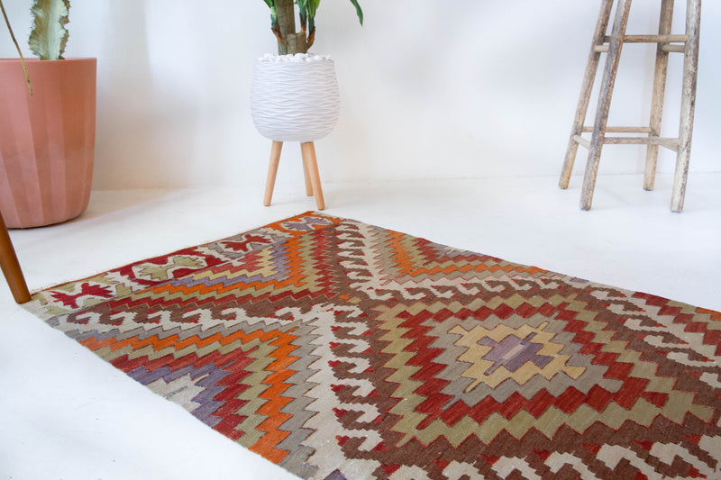 Vintage Turkish runner rug in living room setting, old rug, antique rug, pastel colors, faded colors, Turkish rug, vintage rug, soft rug, Portland, Oregon, rug store, rug shop, local shop