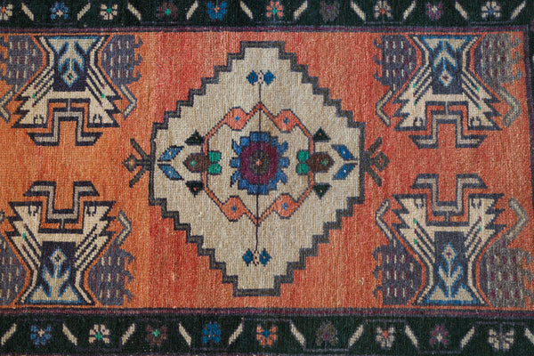 Vintage Turkish mini rug in room decor setting, old rug, antique rug, pastel colors, faded colors, Turkish rug, vintage rug, soft rug, Portland, Oregon, rug store, rug shop, local shop