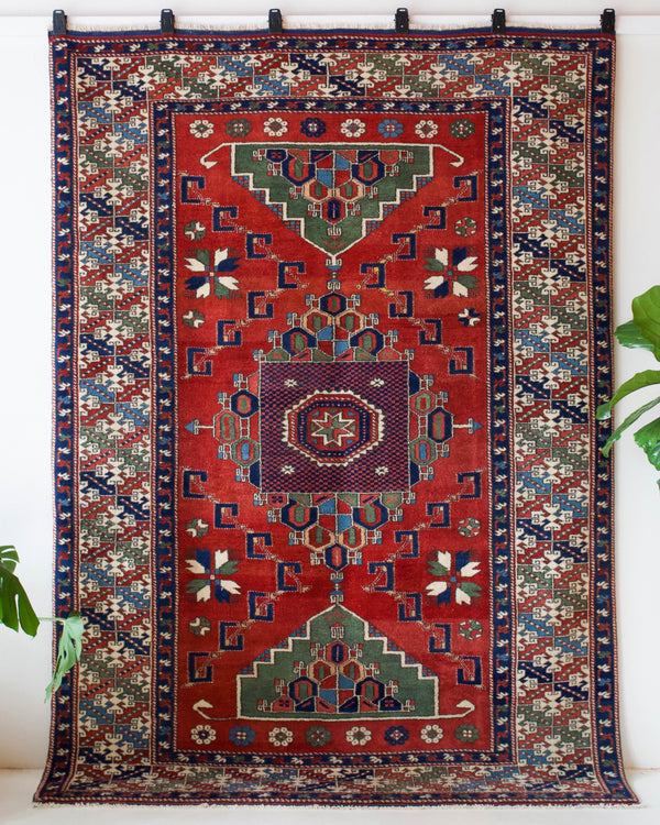 Vintage Turkish rug in a living room setting, pile rug, Turkish rug, vintage rug, portland, rug shop, bright colors, wild shaman, soft rug, bold color, Portland, Oregon, rug store, rug shop, local shop, antique rug