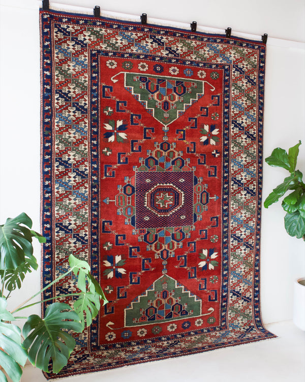 Vintage Turkish rug in a living room setting, pile rug, Turkish rug, vintage rug, portland, rug shop, bright colors, wild shaman, soft rug, bold color, Portland, Oregon, rug store, rug shop, local shop, antique rug