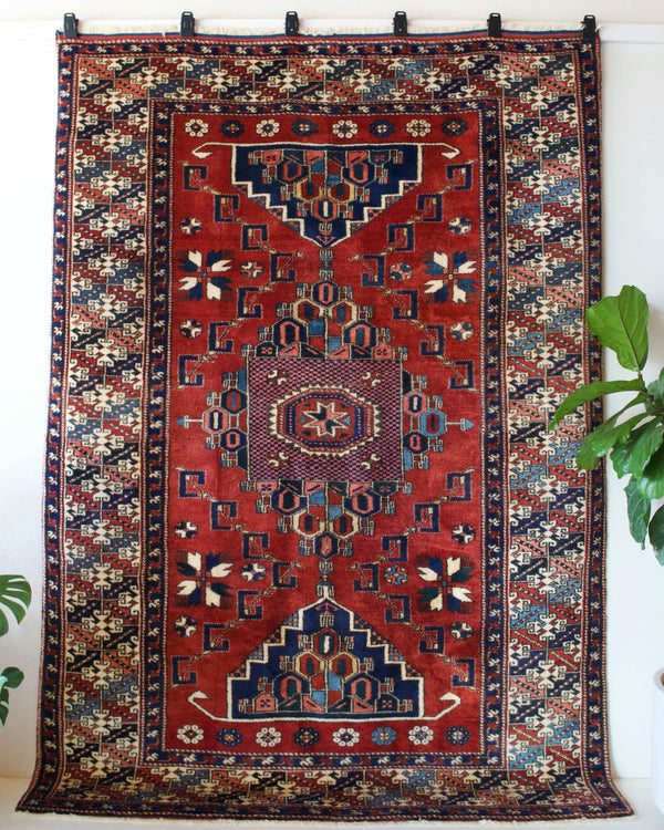 Vintage Turkish rug in a living room setting, pile rug, Turkish rug, vintage rug, portland, rug shop, bright colors, wild shaman, soft rug, bold color, Portland, Oregon, rug store, rug shop, local shop, antique rug