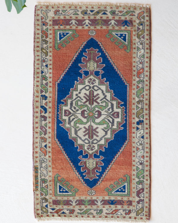 Vintage Turkish mini rug in room decor setting, old rug, antique rug, pastel colors, faded colors, Turkish rug, vintage rug, soft rug, Portland, Oregon, rug store, rug shop, local shop