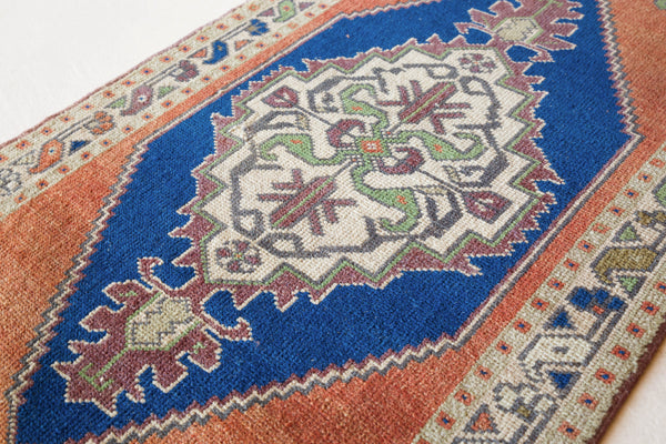 Vintage Turkish mini rug in room decor setting, old rug, antique rug, pastel colors, faded colors, Turkish rug, vintage rug, soft rug, Portland, Oregon, rug store, rug shop, local shop