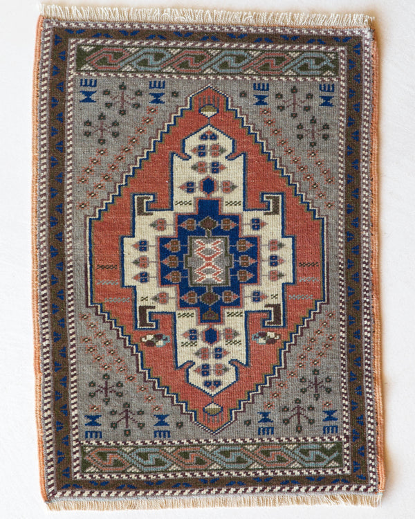 Vintage Turkish mini rug in room decor setting, old rug, antique rug, pastel colors, faded colors, Turkish rug, vintage rug, soft rug, Portland, Oregon, rug store, rug shop, local shop