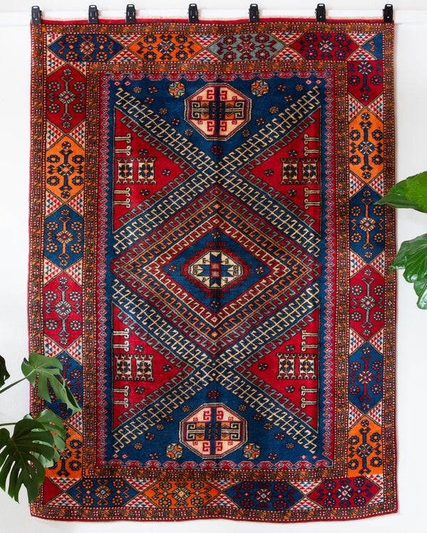 Vintage Turkish rug in a living room setting, pile rug, Turkish rug, vintage rug, portland, rug shop, bright colors, wild shaman, soft rug, bold color, Portland, Oregon, rug store, rug shop, local shop