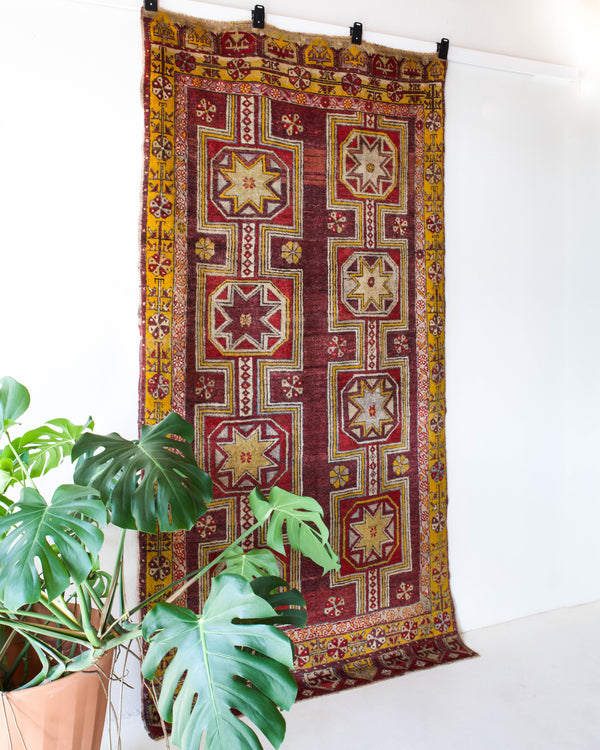 Vintage Turkish rug in a living room setting, pile rug, Turkish rug, vintage rug, portland, rug shop, bright colors, wild shaman, soft rug, bold color, Portland, Oregon, rug store, rug shop, local shop, antique rug, distressed rug, worn out rug