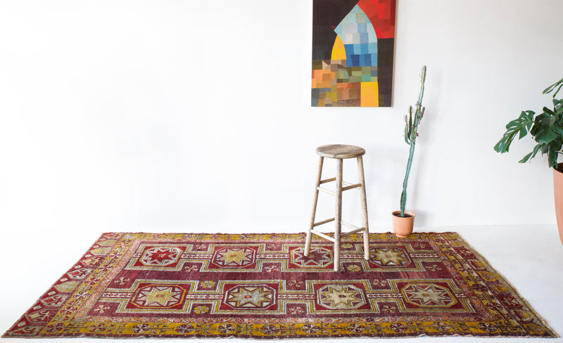 Vintage Turkish rug in a living room setting, pile rug, Turkish rug, vintage rug, portland, rug shop, bright colors, wild shaman, soft rug, bold color, Portland, Oregon, rug store, rug shop, local shop, antique rug, distressed rug, worn out rug