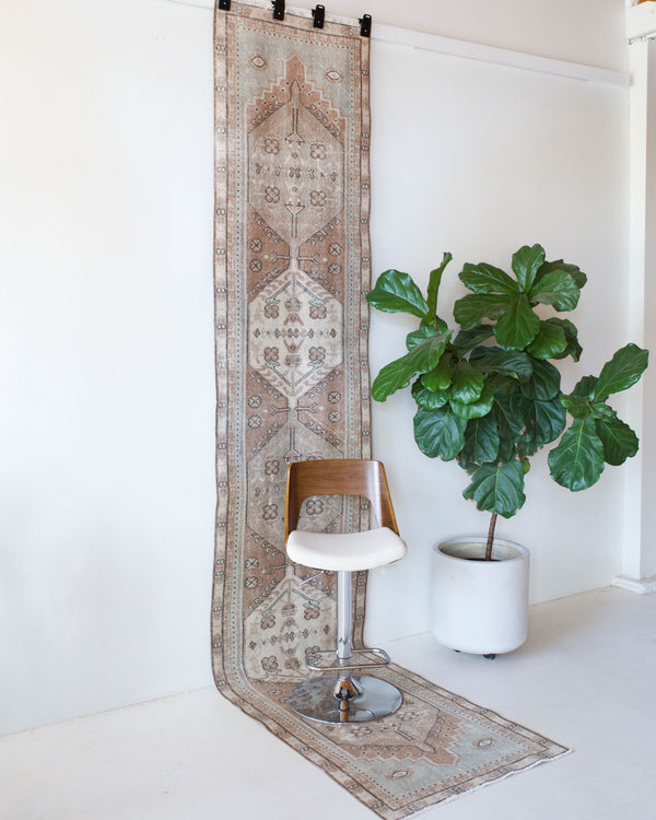 Vintage Turkish runner rug in living room setting, old rug, antique rug, pastel colors, faded colors, Turkish rug, vintage rug, soft rug, Portland, Oregon, rug store, rug shop, local shop