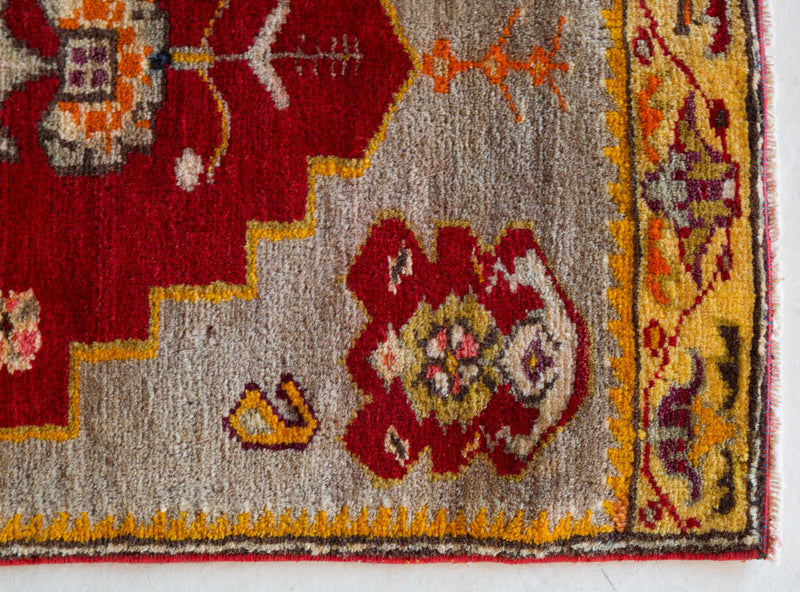 Vintage Turkish mini rug in room decor setting, old rug, antique rug, pastel colors, faded colors, Turkish rug, vintage rug, soft rug, Portland, Oregon, rug store, rug shop, local shop