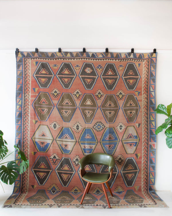 Vintage kilim rug in living room setting, old rug, antique rug, pastel colors, faded colors, Turkish rug, vintage rug, soft rug, Portland, Oregon, rug store, rug shop, local shop