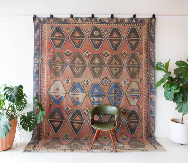 Vintage kilim rug in living room setting, old rug, antique rug, pastel colors, faded colors, Turkish rug, vintage rug, soft rug, Portland, Oregon, rug store, rug shop, local shop