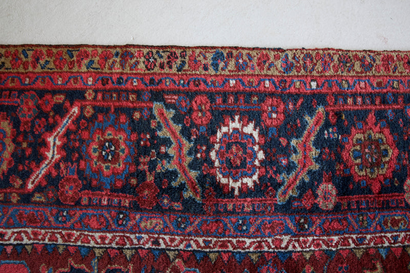 Antique Persian area rug in a living room setting, pile rug, vintage rug, portland, rug shop, bright colors, wild shaman, soft rug, bold color, Portland, Oregon, rug store, rug shop, local shop, antique rug, Persian rug, handmade rug, wool rug