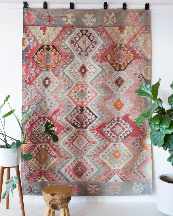 Vintage kilim rug in room decor setting, old rug, antique rug, pastel colors, faded colors, Turkish rug, vintage rug, soft rug, Portland, Oregon, rug store, rug shop, local shop, bold colors, bright colors