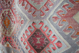 Vintage kilim rug in room decor setting, old rug, antique rug, pastel colors, faded colors, Turkish rug, vintage rug, soft rug, Portland, Oregon, rug store, rug shop, local shop, bold colors, bright colors
