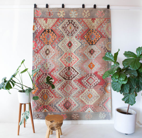 Vintage kilim rug in room decor setting, old rug, antique rug, pastel colors, faded colors, Turkish rug, vintage rug, soft rug, Portland, Oregon, rug store, rug shop, local shop, bold colors, bright colors