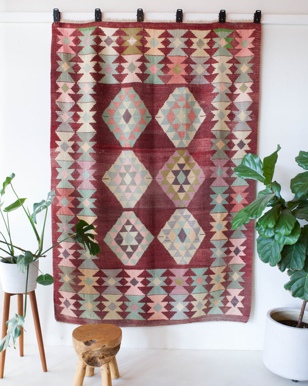 Vintage kilim rug in room decor setting, old rug, antique rug, pastel colors, faded colors, Turkish rug, vintage rug, soft rug, Portland, Oregon, rug store, rug shop, local shop, bold colors, bright colors