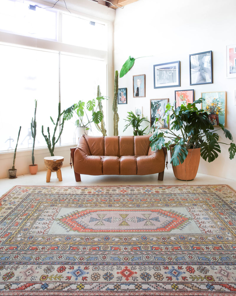 Vintage Turkish rug in living room setting, old rug, antique rug, pastel colors, faded colors, Turkish rug, vintage rug, soft rug, Portland, Oregon, rug store, rug shop, local shop