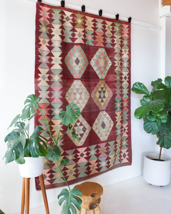 Vintage kilim rug in room decor setting, old rug, antique rug, pastel colors, faded colors, Turkish rug, vintage rug, soft rug, Portland, Oregon, rug store, rug shop, local shop, bold colors, bright colors