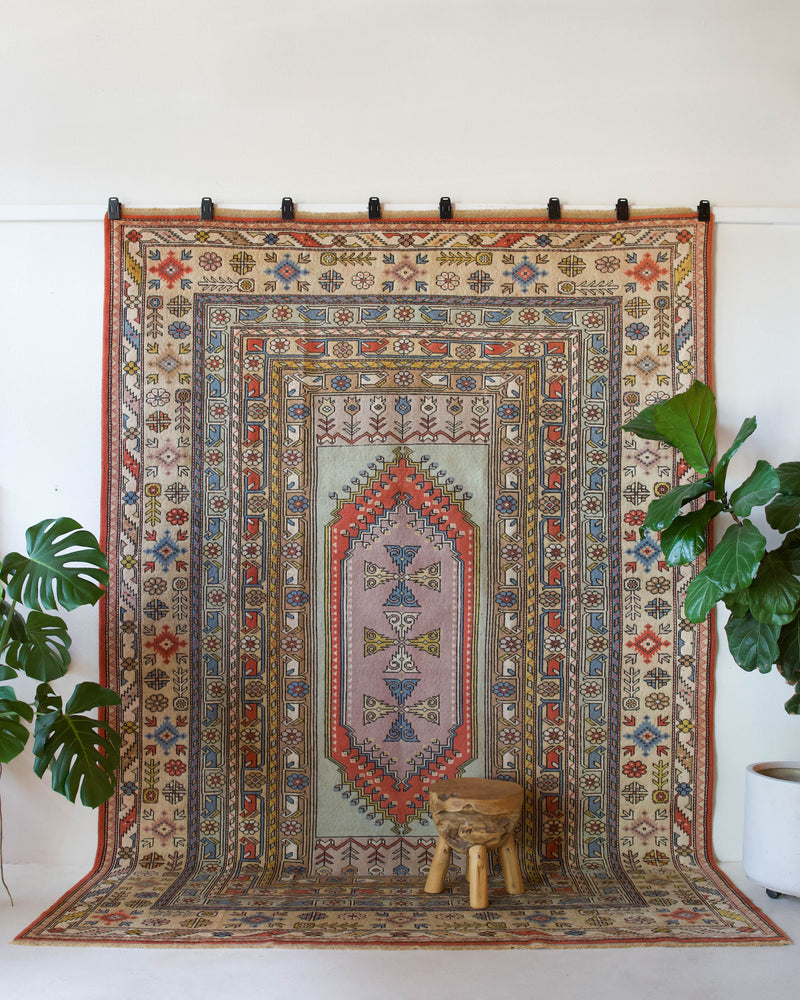 Vintage Turkish rug in living room setting, old rug, antique rug, pastel colors, faded colors, Turkish rug, vintage rug, soft rug, Portland, Oregon, rug store, rug shop, local shop