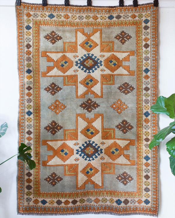 Vintage caucasian rug in a living room setting, pastel colors, faded colors, Turkish rug, vintage rug, soft rug, Portland, Oregon, rug store, rug shop, local shop