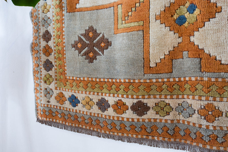 Vintage caucasian rug in a living room setting, pastel colors, faded colors, Turkish rug, vintage rug, soft rug, Portland, Oregon, rug store, rug shop, local shop